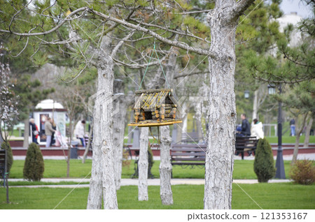A bird feeder in the shape of a house made of wooden blocks A bird feeder in the shape of a house made of wooden blocks 121353167