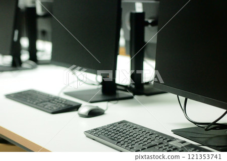 Image of many desktop computers lined up 121353741