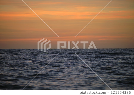 Dramatic red ocean waves at sunset with soft evening sea dark water 121354386