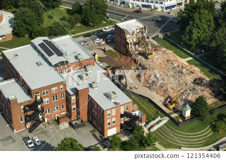 Demolition of Historic Edwards Building in Berea, Kentucky. Crawler excavator demolishing brick walls of old structure Demolition of Historic Edwards Building in Berea, Kentucky. Crawler excavator demolishing brick walls of old structure 121354406