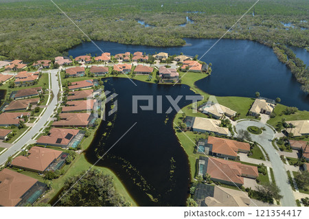 Consequences of natural disaster. Heavy flood with high water surrounding residential houses after hurricane Ian rainfall in Florida residential area Consequences of natural disaster. Heavy flood with high water surrounding residential houses after hurricane Ian rainfall in Florida residential area 121354417