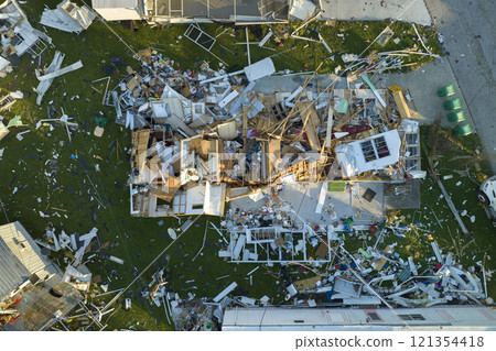 Consequences of natural disaster in southern Florida after hurricane season. Severely damaged houses in mobile home residential area Consequences of natural disaster in southern Florida after hurricane season. Severely damaged houses in mobile home residential area 121354418