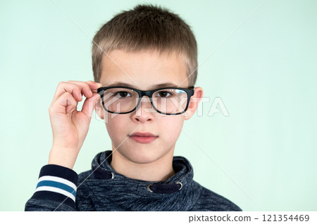 Close up portrait of a child school boy wearing glasses. 121354469
