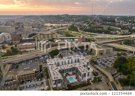 Cincinnati, Ohio highway traffic. Above view of wide freeway junction at sunset with fast driving cars. USA transportation infrastructure concept Cincinnati, Ohio highway traffic. Above view of wide freeway junction at sunset with fast driving cars. USA transportation infrastructure concept 121354484