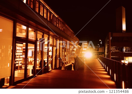 Sepia-toned Tokuyama Station Building Library and the lights of an arriving train Sepia-toned Tokuyama Station Building Library and the lights of an arriving train 121354486
