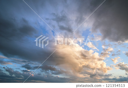 Bright landscape of dark clouds on yellow sunset sky in evening. Bright landscape of dark clouds on yellow sunset sky in evening. 121354513