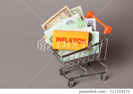 Shopping cart American Dollars money Inflation, Prices rise and Budgeting concept. Cost of Living. Consumer Price Index Shopping cart American Dollars money Inflation, Prices rise and Budgeting concept. Cost of Living. Consumer Price Index 121354573