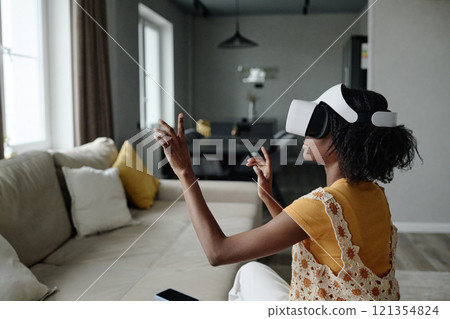 Medium close up of African American woman gesticulating frantically while immersed into gaming process Medium close up of African American woman gesticulating frantically while immersed into gaming process 121354824