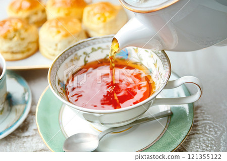 An elegant English afternoon tea with tea and freshly baked scones 121355122