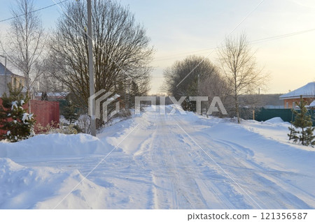 Snowy European village road on a sunny day in December. High quality photo 121356587