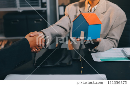 Close up Business people or Real Estate agent explain signing agreement for sale house to client. Property, Insurance, Broker concept. Close up Business people or Real Estate agent explain signing agreement for sale house to client. Property, Insurance, Broker concept. 121356875