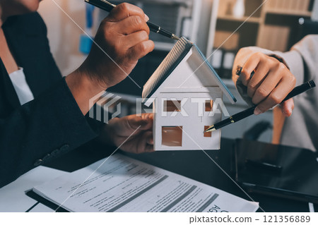 Close up Business people or Real Estate agent explain signing agreement for sale house to client. Property, Insurance, Broker concept. 121356889