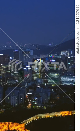 Seoul downtown cityscape and Namsan Seoul Tower and illuminated fortress wall. Seoul, South Korea. Seoul downtown cityscape and Namsan Seoul Tower and illuminated fortress wall. Seoul, South Korea. 121357653