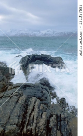 Waves of Norwegian sea crushing on rocky coast in fjord. Vikten, Lofoten islands, Norway Waves of Norwegian sea crushing on rocky coast in fjord. Vikten, Lofoten islands, Norway 121357682
