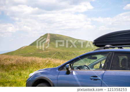 Blue off road car on mountain trail. Traveling by auto, adventure in wildlife, expedition or extreme travel on SUV automobile 121358253