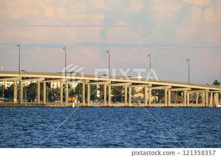 Barron Collier Bridge and Gilchrist Bridge in Florida with moving traffic. Transportation infrastructure in Charlotte County connecting Punta Gorda and Port Charlotte over Peace River Barron Collier Bridge and Gilchrist Bridge in Florida with moving traffic. Transportation infrastructure in Charlotte County connecting Punta Gorda and Port Charlotte over Peace River 121358357