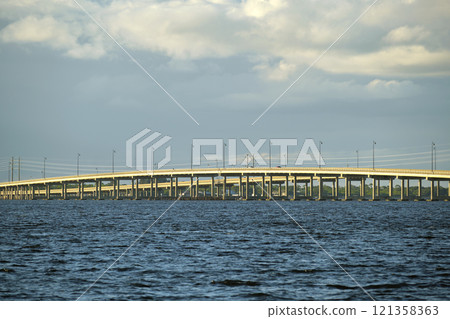 Barron Collier Bridge and Gilchrist Bridge in Florida with moving traffic. Transportation infrastructure in Charlotte County connecting Punta Gorda and Port Charlotte over Peace River 121358363