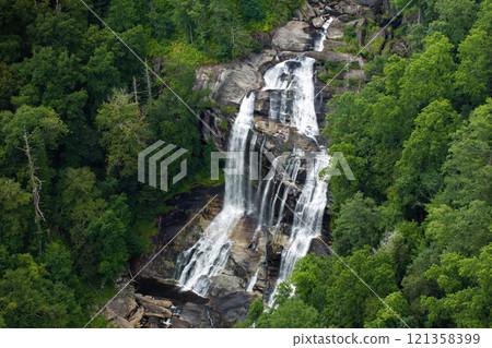 Amazing summer landscape with forest river waters falling down in big waterfall with clear water between rocky boulders in Nantahala National Forest. Whitewater Falls, North Carolina, USA 121358399
