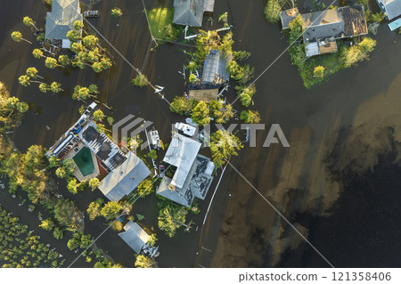 Aftermath of natural disaster. Surrounded by hurricane Ian rainfall flood waters homes in Florida residential area Aftermath of natural disaster. Surrounded by hurricane Ian rainfall flood waters homes in Florida residential area 121358406