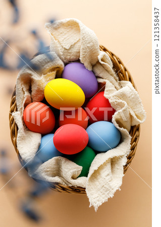 Happy Easer eggs in a basket 121358437