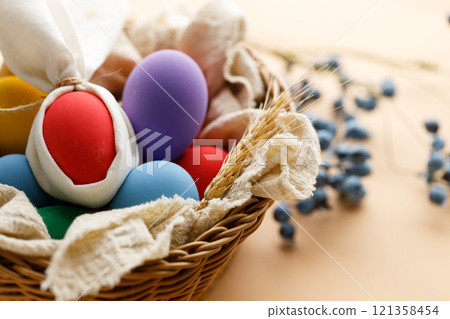 Happy Easer eggs in a basket 121358454