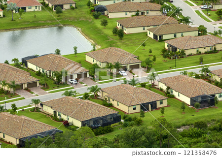 Aerial view of tightly located family houses in Florida closed suburban area. Real estate development in american suburbs Aerial view of tightly located family houses in Florida closed suburban area. Real estate development in american suburbs 121358476