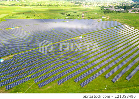 Aerial view of solar power plant on green field. Electric panels for producing clean ecologic energy. 121358496