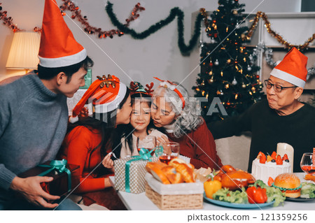 Happy family with gifts celebrating Christmas together Happy family with gifts celebrating Christmas together 121359256