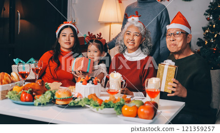 Happy family with gifts celebrating Christmas together Happy family with gifts celebrating Christmas together 121359257