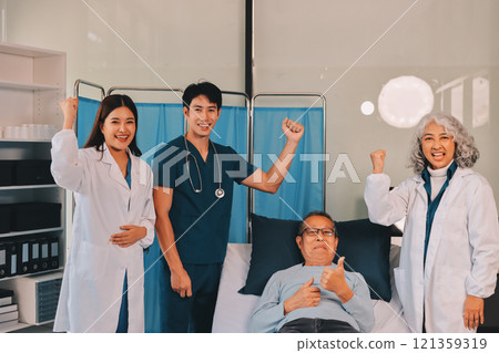 A team of doctors and nurses are working to treat a female patient in the patient's room. A team of doctors and nurses are working to treat a female patient in the patient's room. 121359319