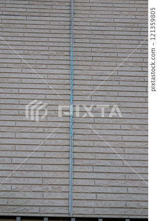 The exterior wall of a house where the sealant had deteriorated and peeled off The exterior wall of a house where the sealant had deteriorated and peeled off 121359805