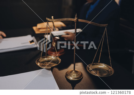 Judge gavel with Justice lawyers having team meeting at law firm background. Concepts of Law and Legal services. 121360178