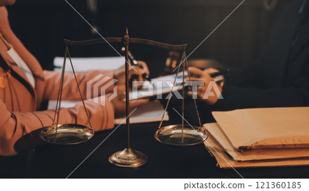 Judge gavel with Justice lawyers having team meeting at law firm background. Concepts of Law and Legal services. 121360185