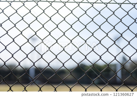 Baseball field through the fence Park Fence December Material Baseball field through the fence Park Fence December Material 121360627