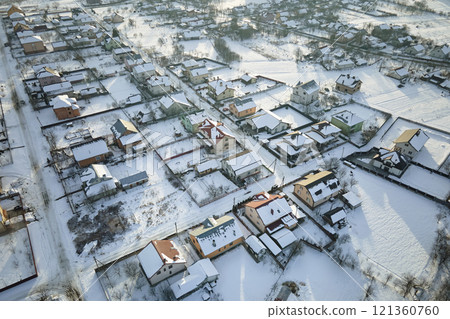 Aerial view of residential houses with snow covered roofops in suburban rural town area in winter Aerial view of residential houses with snow covered roofops in suburban rural town area in winter 121360760