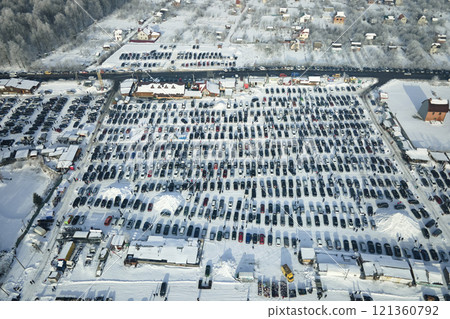 Aerial view of many cars parked for sale and people customers walking on car market or parking lot in winter 121360792