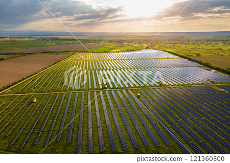 Aerial view of large sustainable electrical power plant with many rows of solar photovoltaic panels for producing clean ecological electric energy. Renewable electricity with zero emission concept. Aerial view of large sustainable electrical power plant with many rows of solar photovoltaic panels for producing clean ecological electric energy. Renewable electricity with zero emission concept. 121360800
