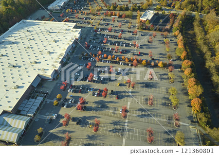Aerial view of large parking lot in front of rgocery store with many parked colorful cars. Carpark at supercenter shopping mall with lines and markings for vehicle places and directions Aerial view of large parking lot in front of rgocery store with many parked colorful cars. Carpark at supercenter shopping mall with lines and markings for vehicle places and directions 121360801