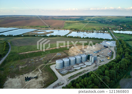 Aerial view of industrial ventilated silos for long term storage of grain and oilseed. Metal elevator for wheat drying in agricultural zone 121360803