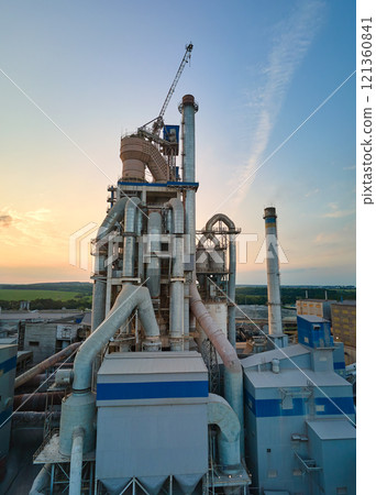 Aerial view of cement factory with high concrete plant structure and tower crane at industrial production site. Manufacture and global industry concept Aerial view of cement factory with high concrete plant structure and tower crane at industrial production site. Manufacture and global industry concept 121360841