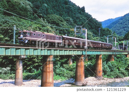 Old passenger car pulled by EF64 electric locomotive on the Joetsu Line 121361229