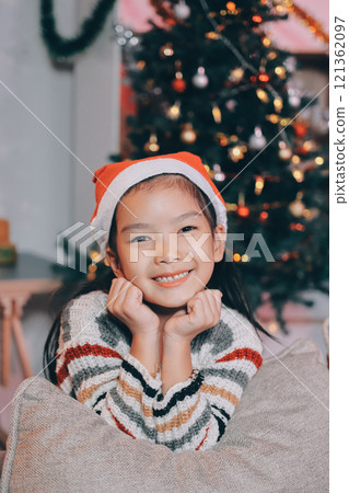 christmas, x-mas, winter, happiness concept - dreaming girl in santa helper hat 121362097