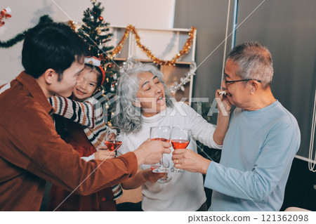 Merry Christmas! Happy family are having dinner at home. Celebration holiday and togetherness near tree. Merry Christmas! Happy family are having dinner at home. Celebration holiday and togetherness near tree. 121362098