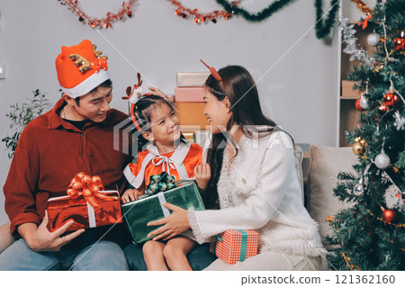 Father, mother and child celebrating Christmas. Father, mother and child celebrating Christmas. 121362160