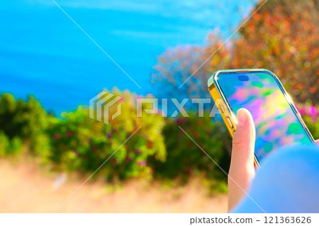 Female hands operating a smartphone Female hands operating a smartphone 121363626