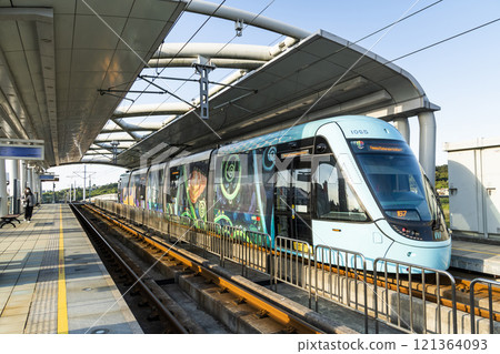 The Danhai Light Rail transit (LRT) train stops at Tamkang University Station in New Taipei City, Taiwan. 121364093