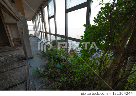 Abandoned hotel on the seafront 121364244