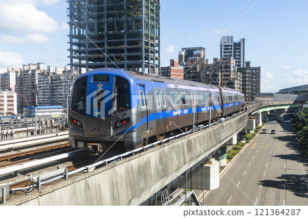 View of a Taoyuan International Airport line train running on the elevated track of the Taoyuan Mass Rapid Transit System. 121364287