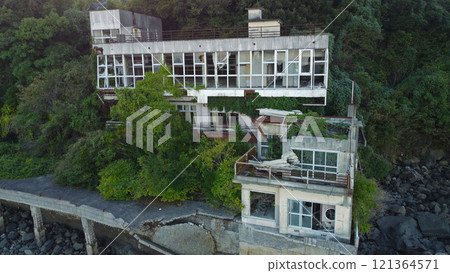 Drone footage of an abandoned hotel by the sea 121364571