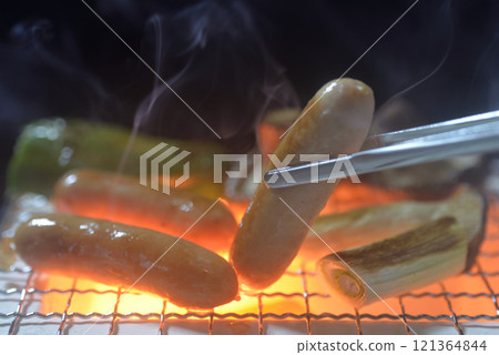 Smoke rising from a charcoal grill as a barbecue Smoke rising from a charcoal grill as a barbecue 121364844